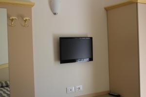 a flat screen tv hanging on a wall at Hotel Marina in Rimini