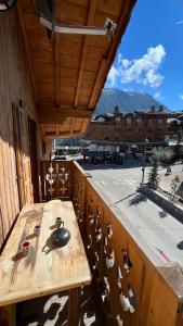 a wooden table on the balcony of a building at l’escalade 3 in Courchevel