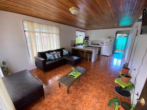 a living room with a couch and a table at Twin Palms Lodge in Monteverde Costa Rica