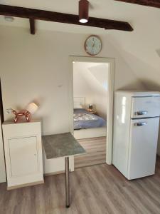 a bedroom with a bed and a mirror and a refrigerator at Kleine Perle bei Hamburg in Reinbek
