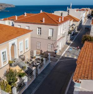 an empty street in a town with buildings at Archontiko Eleni Hotel in Andros