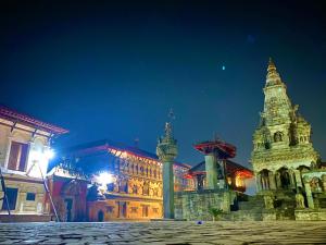 a group of buildings at night with at Shiva Guest House in Bhaktapur