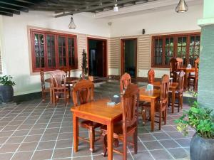 a patio with tables and chairs in a restaurant at Lily Pad Boutique Hotel in Siem Reap