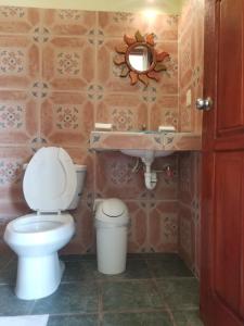 a bathroom with a toilet and a sink at HOTEL ATLANTIDA in Playa del Carmen