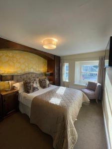 una camera d'albergo con un grande letto e una finestra di Cocketts Hotel a Hawes