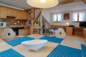 a kitchen and dining room with a table and chairs at Dorfwirt Pfronten in Pfronten