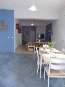a dining room and living room with a table and chairs at Aegean Villa-On beach apartment! Ideal choice! in Masouri