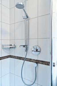 eine Dusche mit Glasduschkopf im Bad in der Unterkunft Gasthof zum Schwan in Sommerach