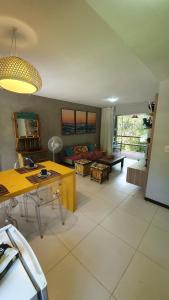 a living room with a couch and a table at Villas do Pratagy Maceió in Maceió