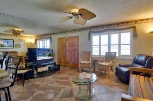 a living room with a couch and a tv at Sunset Chateau 506 - Premier in St Pete Beach