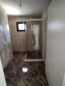 a person taking a picture of a shower in a bathroom at Ferienhaus mit Meerblick in Bodrum City