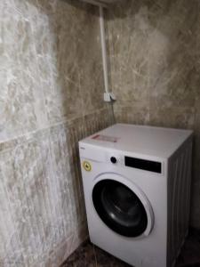a washing machine in a corner of a bathroom at Ferienhaus mit Meerblick in Bodrum City