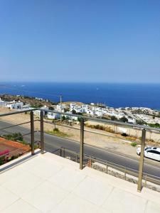 a view of a road and the ocean from a balcony at Ferienhaus mit Meerblick in Bodrum City