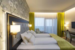 a hotel room with two beds with yellow curtains at Thon Hotel Opera in Oslo