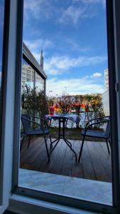 a patio with a table and two chairs on a deck at Hana’s Apartment in Pristina