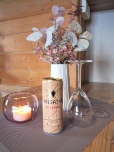 a table with a candle and a vase with flowers at Haus Dorothee in Sautens +34 photos