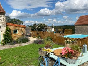 a bike parked in a yard with a pool at Chambres d'Hôtes Maison Balady in Bellenaves