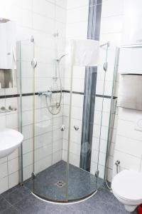 a bathroom with a shower with a sink and a toilet at AJO Vienna Beach - Contactless Check-in in Vienna