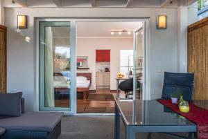 a living room with a glass table and a bedroom at AJO Apartments - Alte Donau Waterfront - Self-Check-in in Vienna