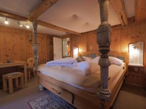 a bedroom with a large bed in a room with wooden walls at Haus Dorothee in Sautens