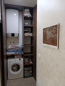 eine Waschküche mit Waschmaschine und Licht in der Unterkunft Apartment Bohemian Dream in Nikšić