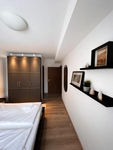 a bedroom with a bed and a hallway at Luxury Apartments Panorama in Donovaly
