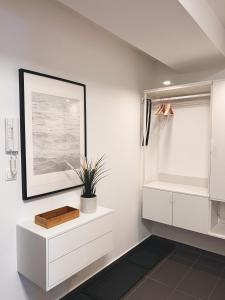 a bathroom with white cabinets and a picture on the wall at Luxury Apartments Panorama in Donovaly