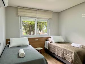 Postel nebo postele na pokoji v ubytování Delle Alpi 2 dorm ao lado Roda Gigante by Achei