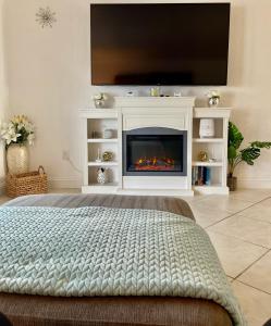 a living room with a fireplace and a tv at Bright and Beachy 2Bed 1Bath Home - Unit 210 in Cocoa Beach