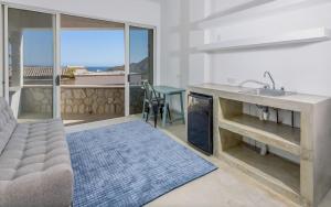 a living room with a couch and a sink at The one and only Pedregal Hollywood House in Cabo San Lucas