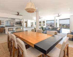 a kitchen and living room with a wooden table and chairs at The one and only Pedregal Hollywood House in Cabo San Lucas