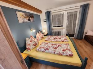 a bedroom with a bed with two pillows on it at am Mühlbach - Pension Luttinger in Bichlbach