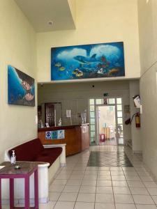 a lobby of a hospital with a fish painting on the wall at HOTEL ATLANTIDA in Playa del Carmen
