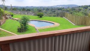 a backyard with a swimming pool and a fence at The Gregory in Pinetown