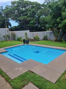 a small blue swimming pool in a yard at Off Shore Ballito in Ballito