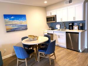 a kitchen with a table and chairs in a kitchen at Beautiful Ocean Views - SEASCAPE - Hot Tubs - Heated Pools - Cozy Fireplace in Aptos