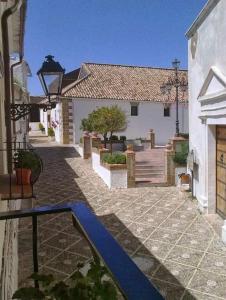 a walkway in a house with a blue path at La Villa, Alojamiento Rural in Iznájar