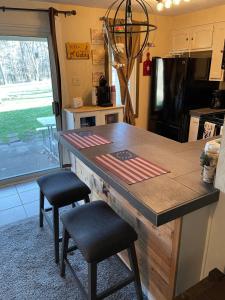 a kitchen with a large wooden counter with stools at Blue Knob Bear Den (Nordic Center/Golf Course) in Claysburg