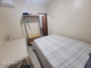 a bedroom with two beds and a mirror in it at Casa Praia dos Milagres-3suítes-piscina-850m da praia in São Miguel dos Milagres