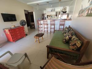 a living room with a couch and a kitchen at Casa Praia dos Milagres-3suítes-piscina-850m da praia in São Miguel dos Milagres