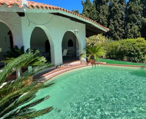 a swimming pool in front of a house at Casale al mare - villa with swimming pool 150 meters from the beach in Porto Columbu - Perdʼe Sali