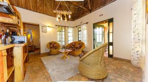 a living room with chairs and a table at Edaala Comfort - Cottage Rooms in Nairobi