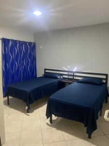 - 2 lits dans une chambre avec des draps bleus dans l'établissement Murdeira Village V155A, à Beirona