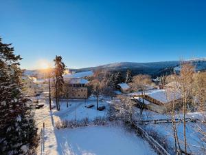 a winter view of a village in the snow at Landhaus-Chalet-Keilberger Blick in Kurort Oberwiesenthal