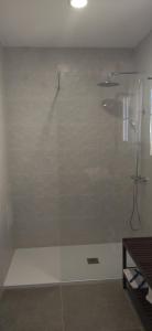 a shower with a glass door in a bathroom at Sunny Holiday Home in Creixell