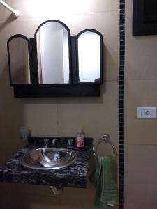 y baño con lavabo y espejo. en # Crespo Suites # en Rosario