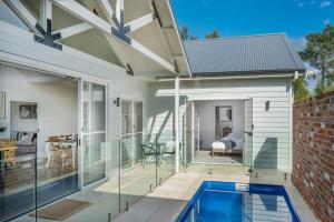 a house with a swimming pool on a patio at McG Mudgee a Hamptons inspired home in Mudgee