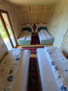 a small room with three beds in it at Konak Mara- Komovi in Andrijevica