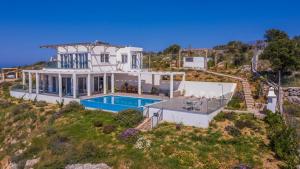 an aerial view of a house with a swimming pool at Villa Cassandra - A breathtaking view of Souda-Chania bay and the White Mountains in Kókkinon Khoríon