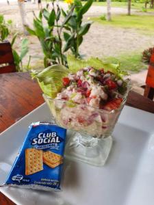 a salad in a plastic container next to a bag of crackers at Surfing Turtle Lodge in Poneloya